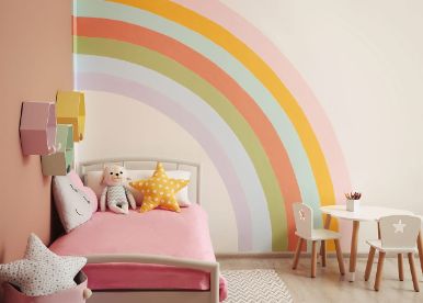 Pastel children's bedroom with a rainbow wall