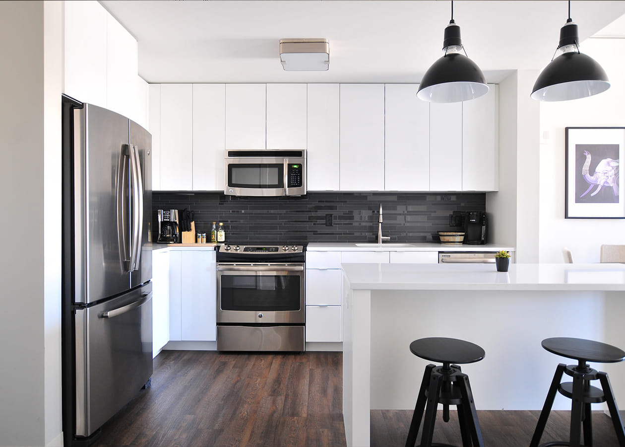 White utilitarian modular kitchen with island