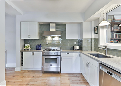 White L-shaped modular kitchen that is aesthetic and utilitarian