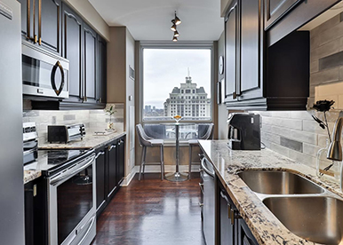 Galley Kitchen with Marble Countertops and Classic Trims